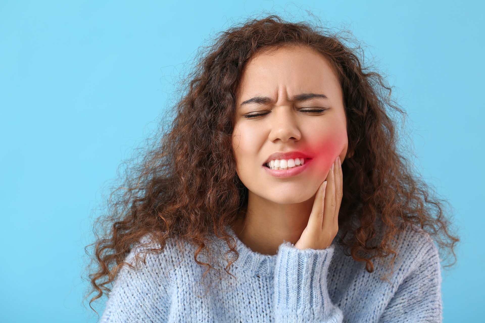 Woman suffering from tooth ache on color background